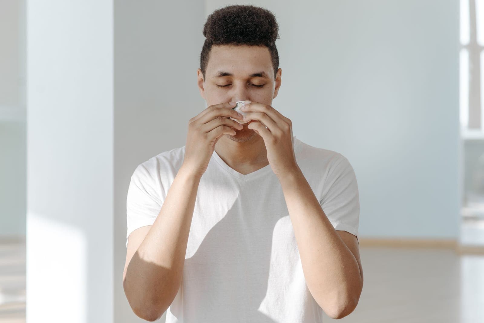 A person holding a tissue in a domestic living room